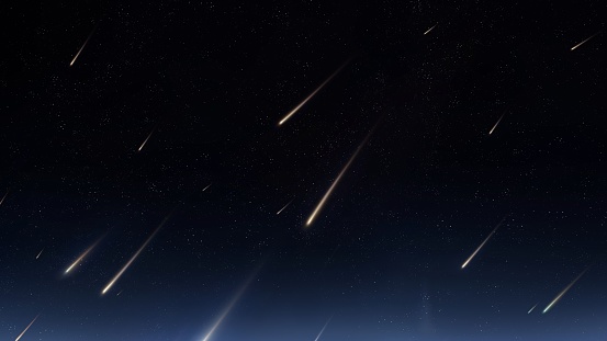 Beautiful starfall in the sky. A stream of meteors reached the Earth. Meteorites glow in the atmosphere.