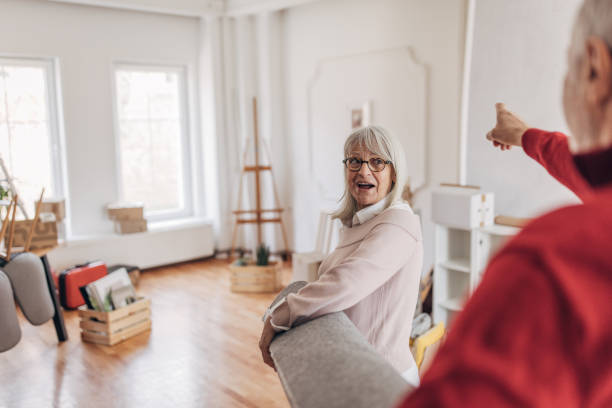 istock Couple carrying a carpet in new home 1483935688