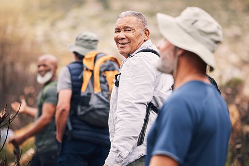 Hiking, nature and senior friends on mountain for fitness, trekking and backpacking adventure. Explorer, discovery and expedition with men mountaineering on trail for health, retirement and journey