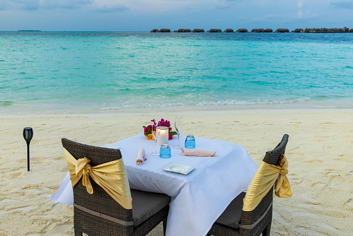 romantic beachside dinner at sunset on the Maldives Atoll
