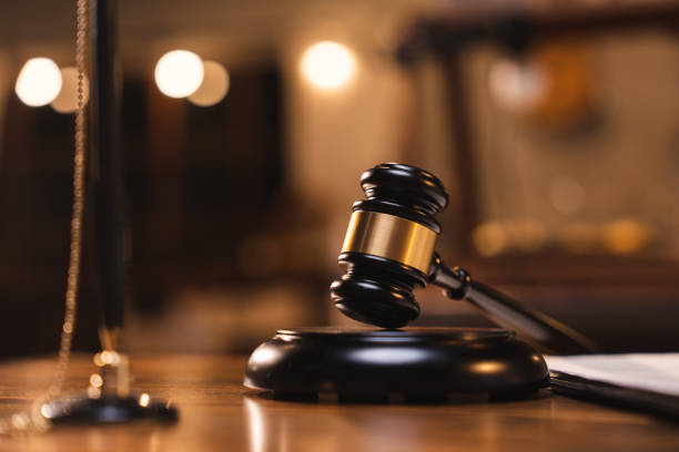 istock Judge gavel on the table with blurry books in the background 1483938846