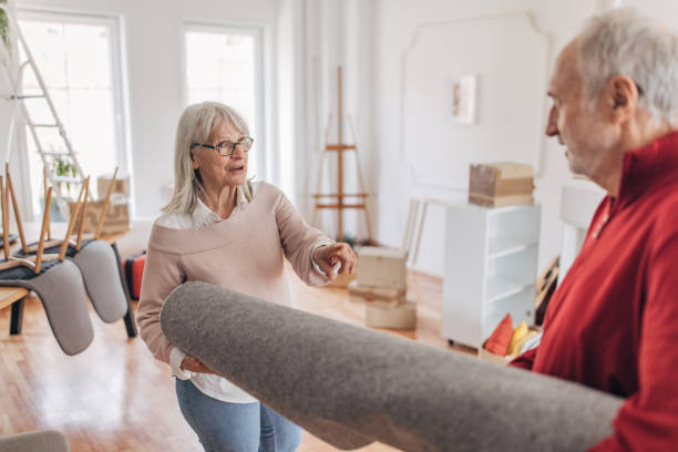 istock Couple carrying a carpet in new home 1483941056
