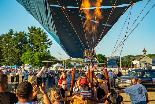 Hudson Valley, NY. USA. 08.07.2018 Hot air balloon festival in Hudson Valley New York, on a beautiful sunny day with lots of people helping, participating, flying and enjoying themselves like the lovely joyous people that they are!