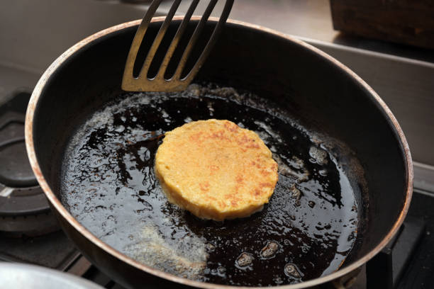istock Flat bread dumpling is fried in butter and oil in a rustic black pan until golden brown, cooking at home, selected focus 1483944924