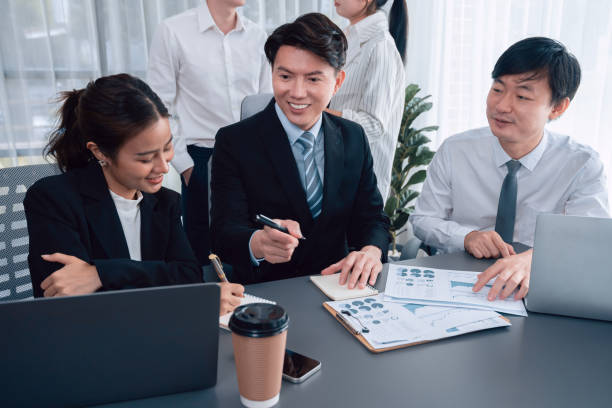 istock Office worker and manager analyze financial report paper in harmony workplace. 1483948108