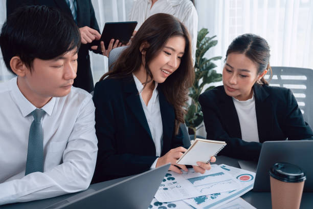 istock Office worker and manager analyze financial report paper in harmony workplace. 1483948216