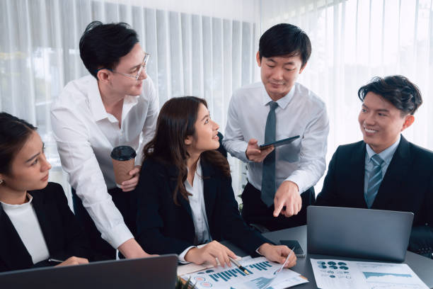 istock Office worker and manager analyze financial report paper in harmony workplace. 1483949006