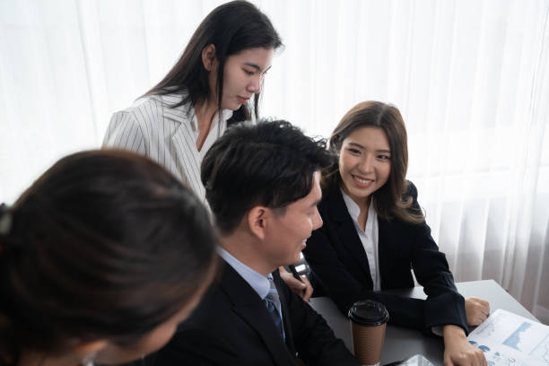 istock Office worker and manager analyze financial report paper in harmony workplace. 1483949084