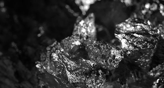 macro shooting of natural rock specimen - piece of graphite mineral gemstone isolated on white background