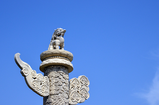 Beijing, China: Huabiao pole with mythical dragon and the sky above Tiananmen Square, erected in the Ming dynasty in the 15th century - ceremonial pillar used in traditional Chinese architecture.