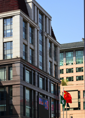 Beijing, China: Macau Center building, the Office of the Macau Special Administrative Region in Beijing, the representative office of Macau in the mainland area of the People's Republic of China - flags of China and the Macau SAR, Macao Liaison Office - Wangfujing East Street, Dongcheng District.