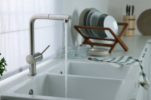 istock Stream of water flowing from tap in kitchen, space for text 1483961903