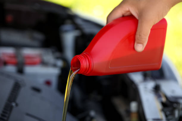 istock Man pouring motor oil from red container, closeup 1483962285