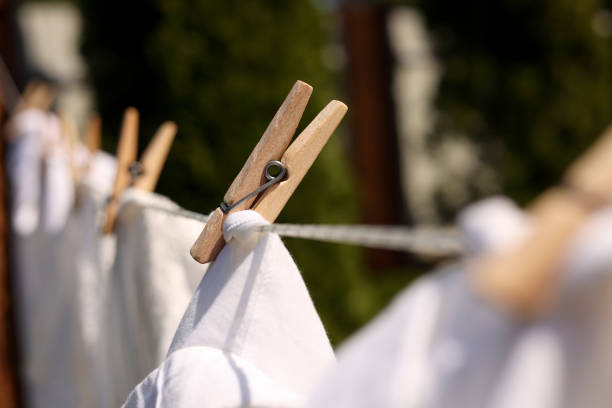 istock Clean clothes drying outdoors, closeup. Focus on clothespin 1483963194