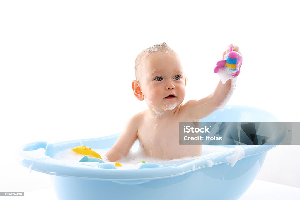 Baby in blue bathtub holding up a toy Bathing Baby Baby - Human Age Stock Photo