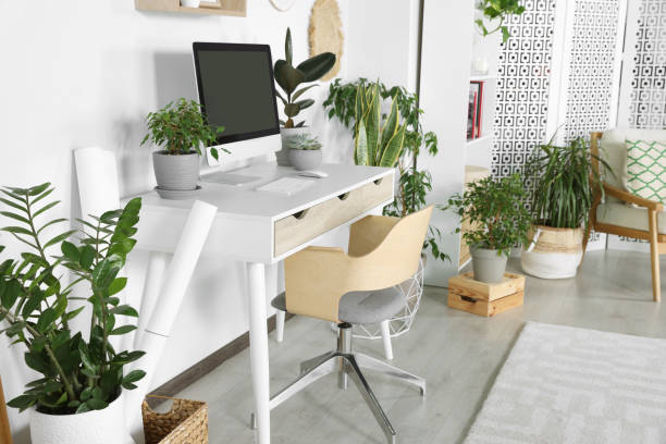 istock Comfortable workplace with modern computer and different houseplants in room 1483968846