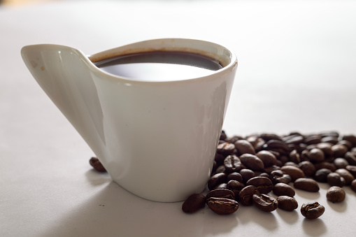 Espresso Coffee Cup With Beans On Vintage Table