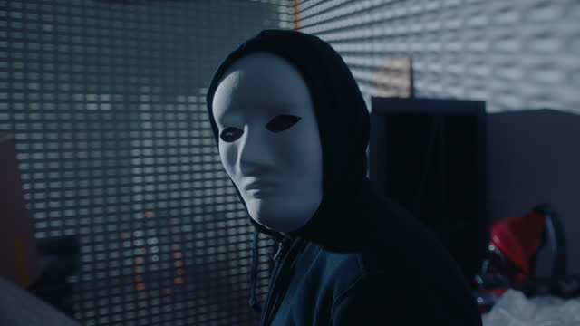 Masked Murderer or Thief Posing for Camera in Dark Garage at Night