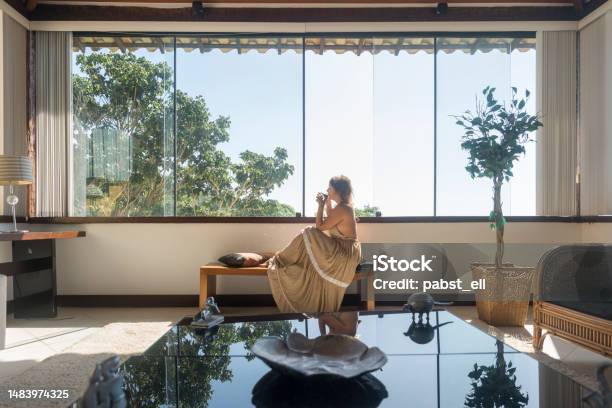 Mature Woman Drinking By Hotel Window Stock Photo - Download Image Now - Fashion, Luxury, Hotel