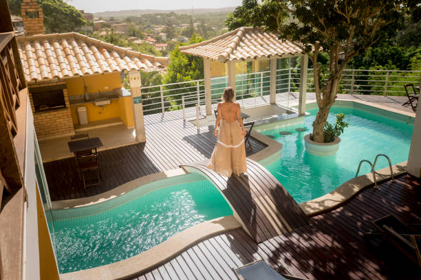istock Woman walking on a bridge over a hotel swimming pool 1483974409