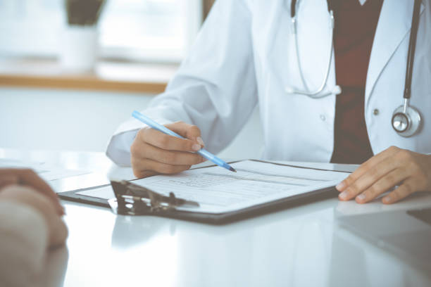 istock Unknown woman-doctor consulting patient and using clipboard with a medication history record. Medicine concept 1483986521