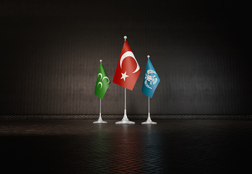 Azerbaijan national flag flying from a building in Baku with Heydar Aliyev conference centre in the background.