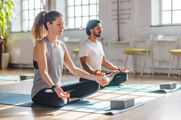 istock A Diverse Couple Meditating Together During A Yoga Class In A Beautiful Studio With Big Windows 1483989719