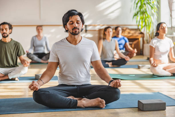 istock A Male Indian Practicing Sukhasana Pose During A Yoga Class In A Cosy Bright Pilates Studio 1483989767
