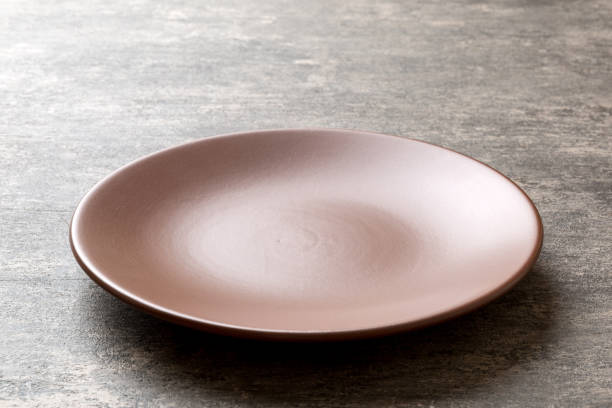 istock Perspective view of empty plate on cement background. Empty space for your design 1483989843