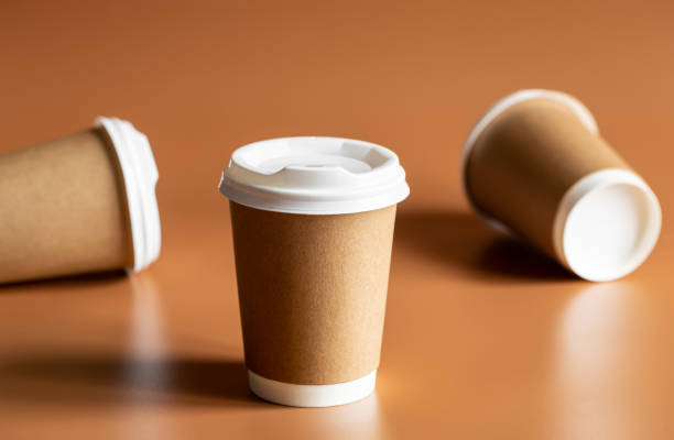 istock Eco-Friendly Craft Disposable Brown Cups on brown background Isolated. 1483990315