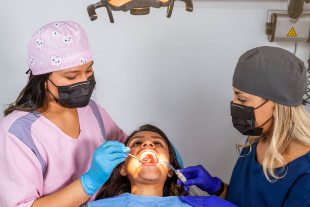 istock Top-Down Perspective of Dentist and Assistant with Patient during a consultant 1483993820