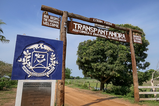 Entrance of the famous Transpantaneira road (here begins the Pantanal) with government emblem (more than pure power) in the Northern Pantanal, Mato Grosso , Brazil