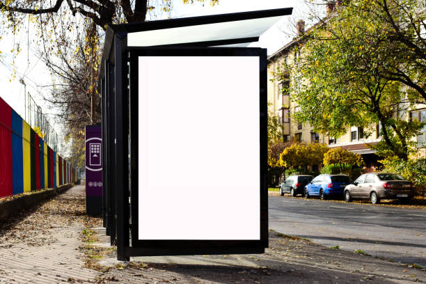 istock bus shelter with lightbox. blank white billboard ad panel at busstop. background for mockup 1484005636