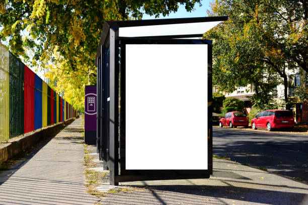 istock bus shelter with lightbox. blank white billboard ad panel at busstop. background for mockup 1484005722