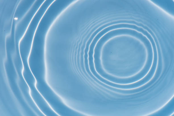 istock Blue water with ripples on the surface. Defocus blurred transparent blue colored clear calm water surface texture with splashes and bubbles. Water waves with shining pattern texture background texture 1484008760