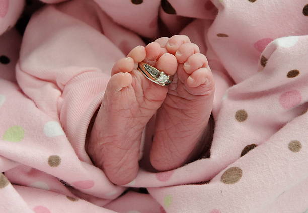 newborn  with wedding rings