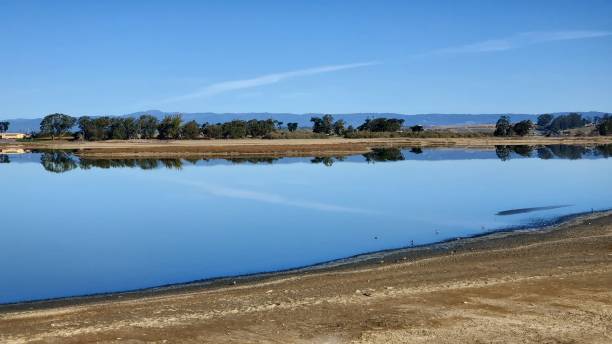 istock Water mirroring sky and ground view 1484015558