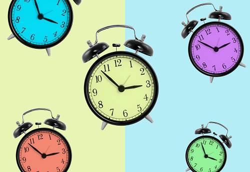 Clocks with different colors isolated on green and blue background, colored background