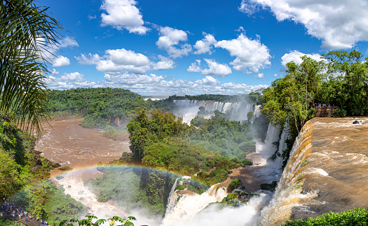 Scenic view from top of the waterfalls with a rainbow to Iguazu river and San Martin Island, Iguazu Falls, Argentina