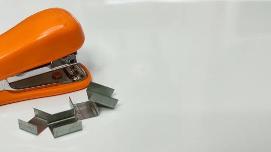Orange stapler with white background
