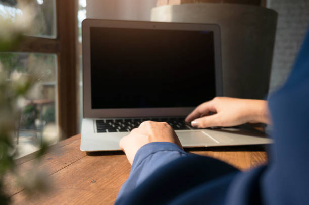 istock Man using, working on laptop with blank screen in meeting room. 1484021012