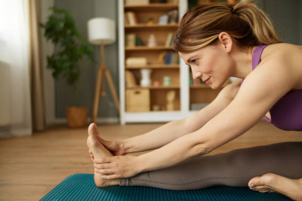 istock Young woman practicing yoga at home 1484023737