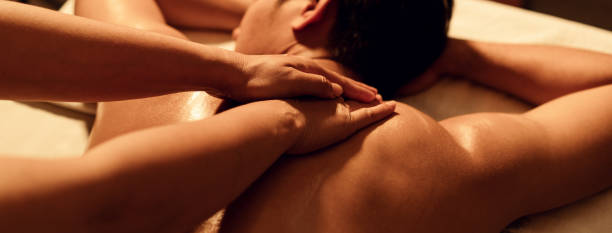 Aromatherapy massage, Masseuse hand massage aroma on back a man customer in cosmetology spa centre.