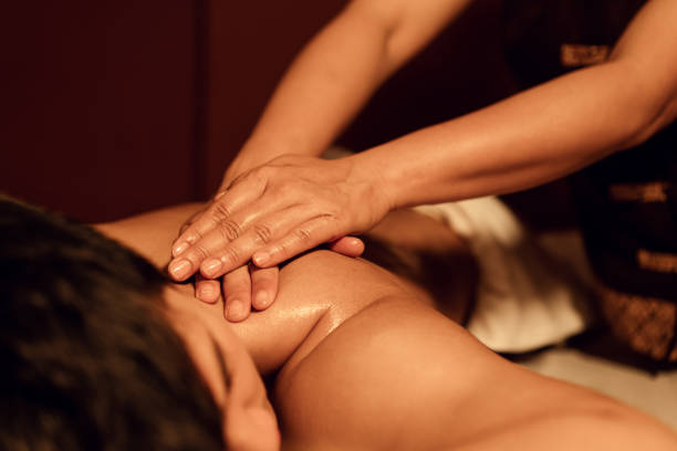 istock Masseuse hand massage aroma on back a man customer in cosmetology spa centre. 1484025984