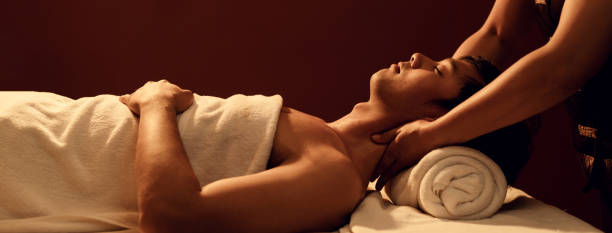 istock Relaxation Asian man customer get service aromatherapy massage neck and shoulder with masseuse in spa salon. 1484026024