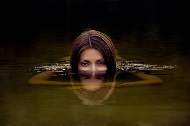 istock girl looking from water 148403198