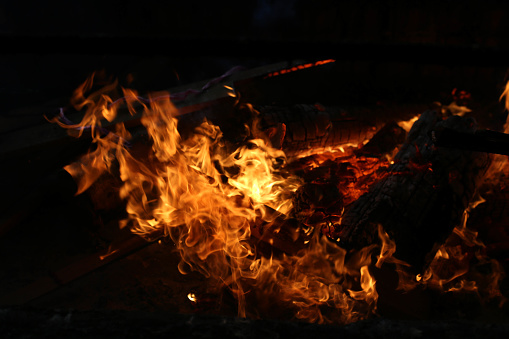 Fierce fire burning timbers for cooking lemang (glutinous rice cooked with coconut milk in hollowed bamboo)
