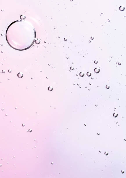 istock Facial serum oil surface with water bubbles. Abstract cosmetic liquid soft pink background for advertising and presentation of cosmetic products. 1484045475