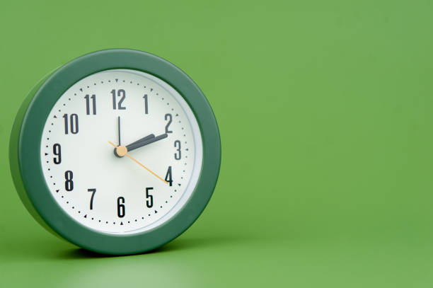 istock alarm clock on green background time concept working with time precious time 1484049207