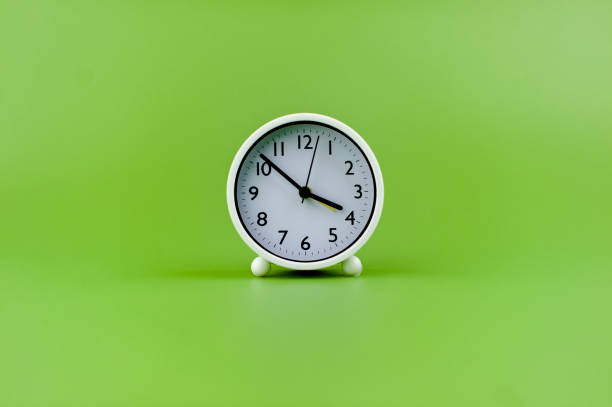 istock alarm clock on green background time concept working with time precious time 1484049215